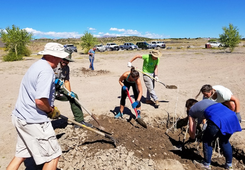 Volunteers plant cottonwood poles near the swim beach at Cochiti Lake, during National Public Lands Day, Sept. 28, 2019.