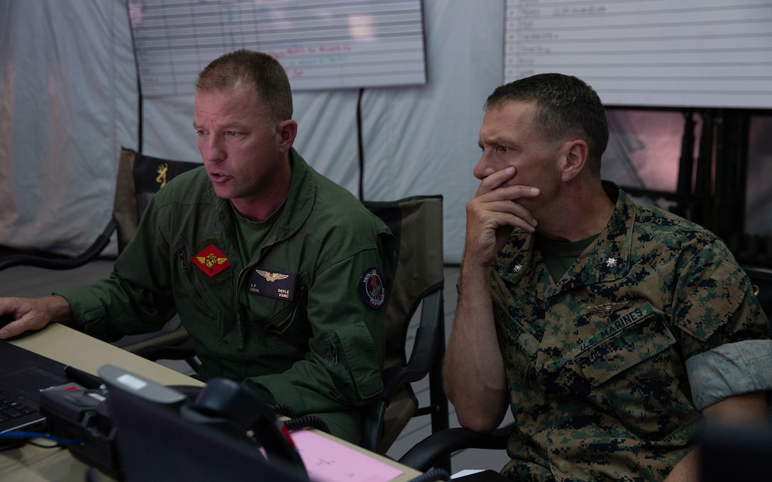Marine Lt. Col. James P. Doyle, left, informs Lt. Col. Kristopher L. Faught on the status of a simulation during Exercise Pegasus Flight at Marine Corps Air Station Cherry Point, North Carolina, Oct. 1, 2019. Pegasus Flight was organized to support unit-level training objectives in a limited capability environment to improve combat readiness and mission effectiveness against near-peer threats. Doyle is a weapons systems officer with Marine Wing Headquarters Squadron 2 and Faught is an operations officer with MWHS-2, 2nd Marine Aircraft Wing. (U.S. Marine Corps photo by Pfc. Steven M. Walls)