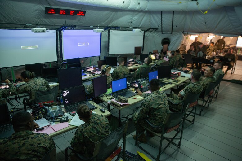 Marines assigned to Marine Tactical Air Command Squadron 28 await orders in the unit's command center during Exercise Pegasus Flight at Marine Corps Air Station Cherry Point, North Carolina, Oct. 1, 2019. MTACS-28 supported Pegasus Flight by planning, commanding, directing and supervising all air operations as the tactical air command center for the exercise. MTACS-28 is a part of Marine Air Control Group 28, 2nd Marine Aircraft Wing. (U.S. Marine Corps photo by Pfc. Steven M. Walls)
