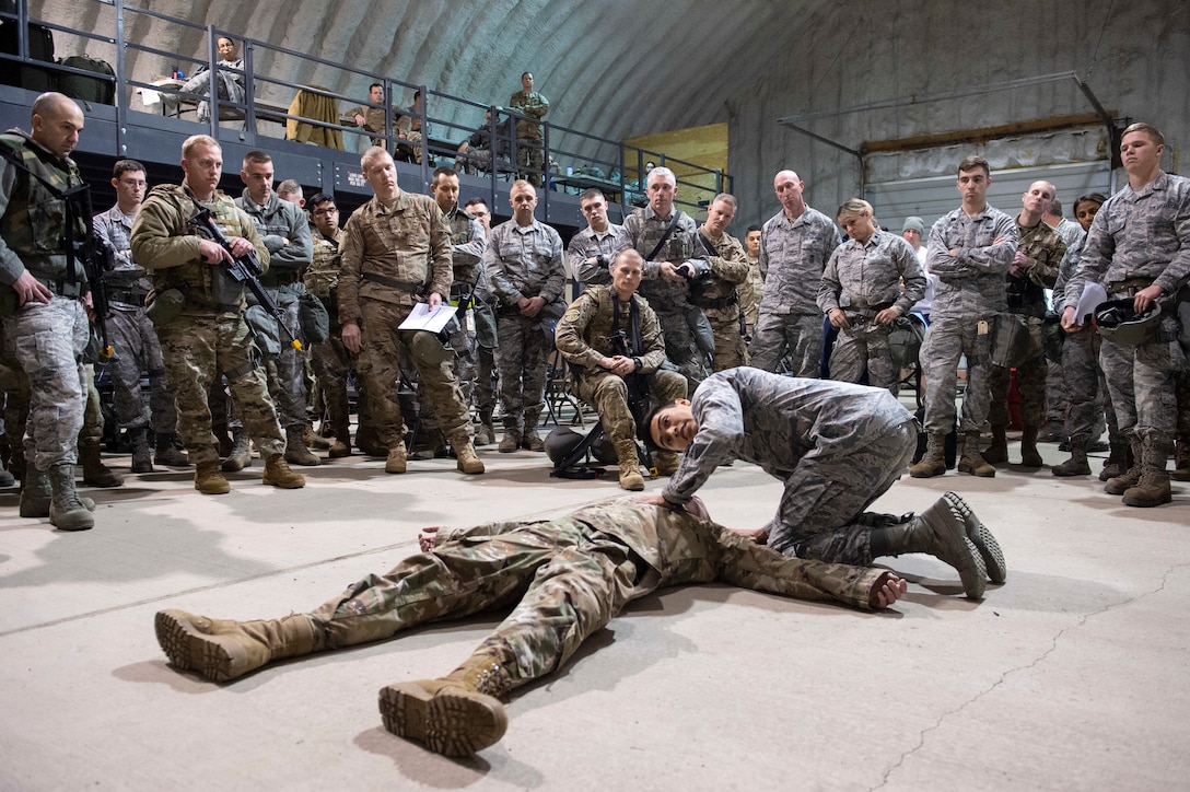 Staff Sgt. performs a simulated casualty assessment