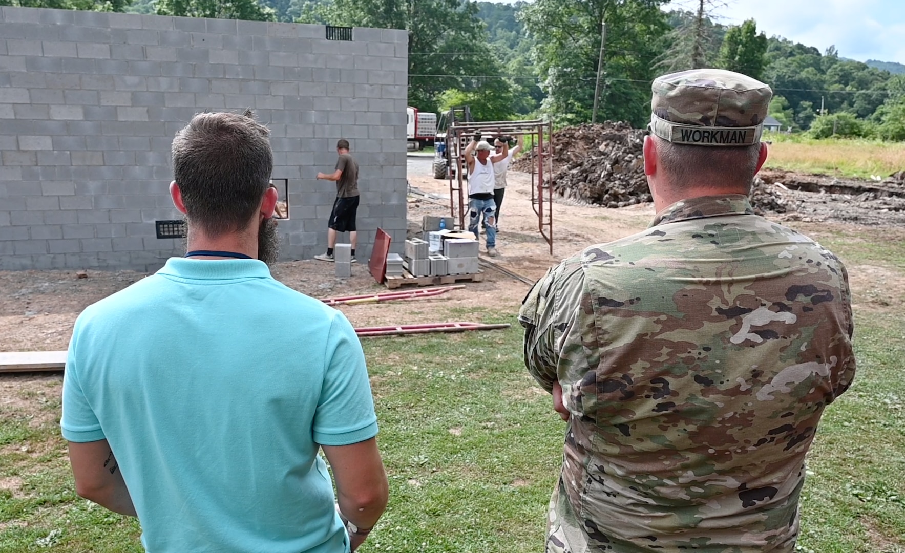 Soldier and contractor overseeing home construction.