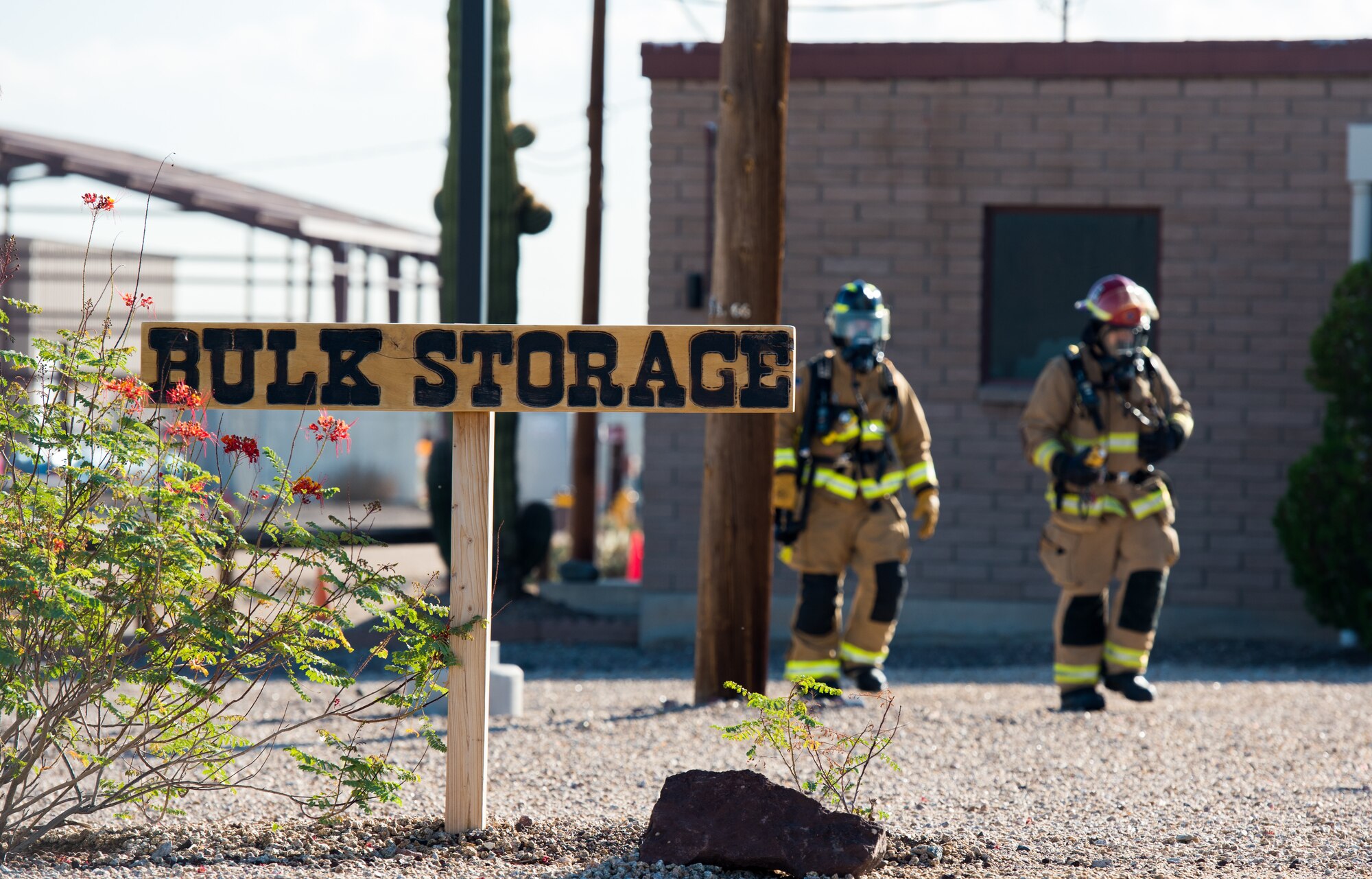 Two 56th Civil Engineer Squadron firefighters walk through a fuel storage area during a fuel spill exercise Oct. 4, 2019, at Luke Air Force Base, Ariz.