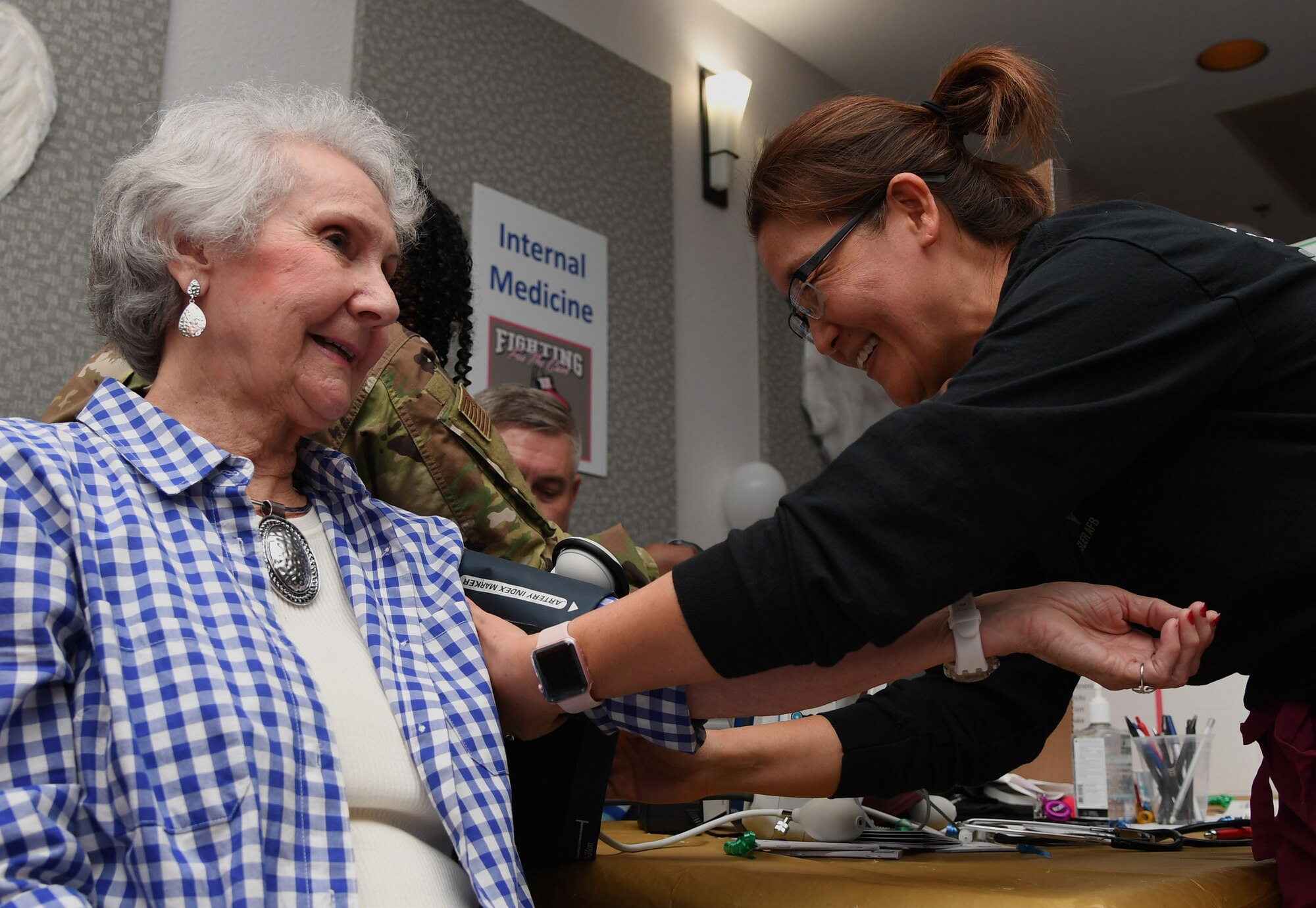 Stacy Latack, 81st Medical Group disease management nurse, checks the blood pressure of Ellie Warren, widow of U.S. Air Force retired Master Sgt. Robert Warren, during the 81st Medical Group Health Expo inside the Keesler Medical Center at Keesler Air Force Base, Mississippi, Oct. 4, 2019. The 81st MDG hosted the walk-in event which included screenings for multiple types of cancer and chronic diseases in honor of Breast Cancer Awareness Month. (U.S. Air Force photo by Kemberly Groue)