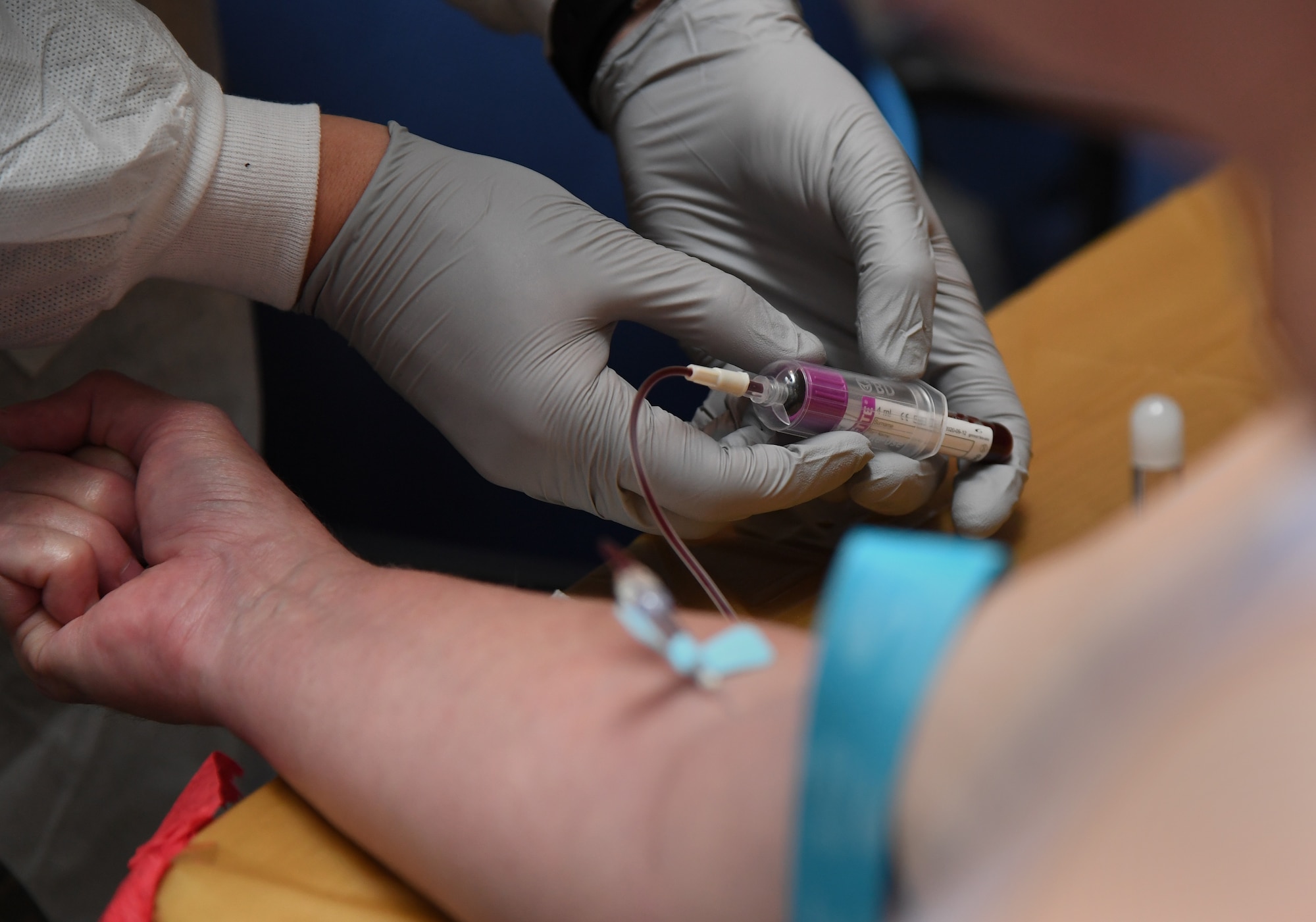 U.S. Air Force Airman Jared Fleming, 81st Diagnostic and Therapeutics Squadron medical lab technician, draws blood from Sheila Wood, spouse of U.S. Navy retired Scorekeeper Chester Wood, during the 81st Medical Group Health Expo inside the Keesler Medical Center at Keesler Air Force Base, Mississippi, Oct. 4, 2019. The 81st MDG hosted the walk-in event which included screenings for multiple types of cancer and chronic diseases in honor of Breast Cancer Awareness Month. (U.S. Air Force photo by Kemberly Groue)