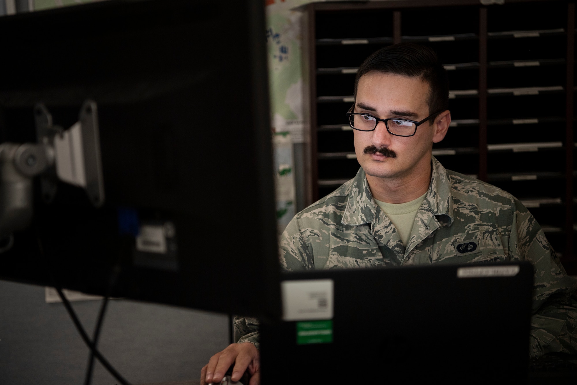 Airman 1st Class Aws Hussein, 66th Comptroller Squadron financial management technician, works the finance customer service desk on Hanscom Air Force Base, Massachusetts, Oct. 10. Originally from Baghdad, Iraq, Hussein served alongside coalition forces as an Arabic interpreter from 2007 to 2011 before immigrating to the U.S. in 2013.