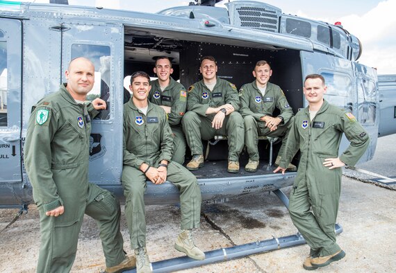 (From left to right) U.S. Air Force students 2nd Lt. Trent Badger, 2nd Lt. J. Karl Bossard, 1st Lt. Matthew Gulotta, 2nd Lt. John Thrash, Capt. Josh Park, and 2nd Lt. Richard Songster with a TH-1H helicopter at Fort Rucker, Ala., Oct. 10, 2019. All six officers graduated from Specialized Undergraduate Pilot Training - Helicopter Class 20-02, which incorporated virtual reality in an experimental curriculum that resulted in the class graduating six weeks earlier than normal training classes while reducing actual flying time in the TH-1H by about 35%. (U.S. Air Force courtesy photo/Brian Braden)