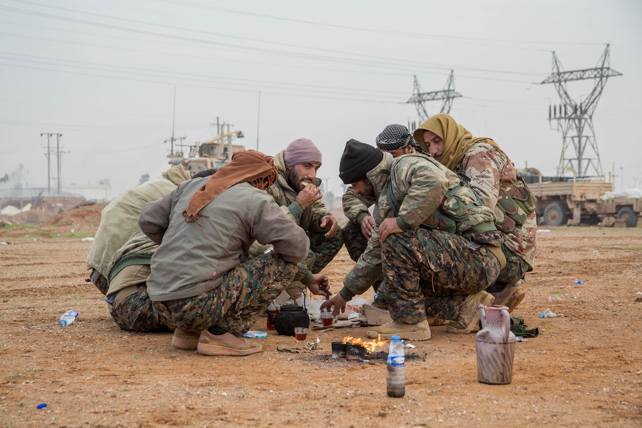 Soldiers eat breakfast in the field.