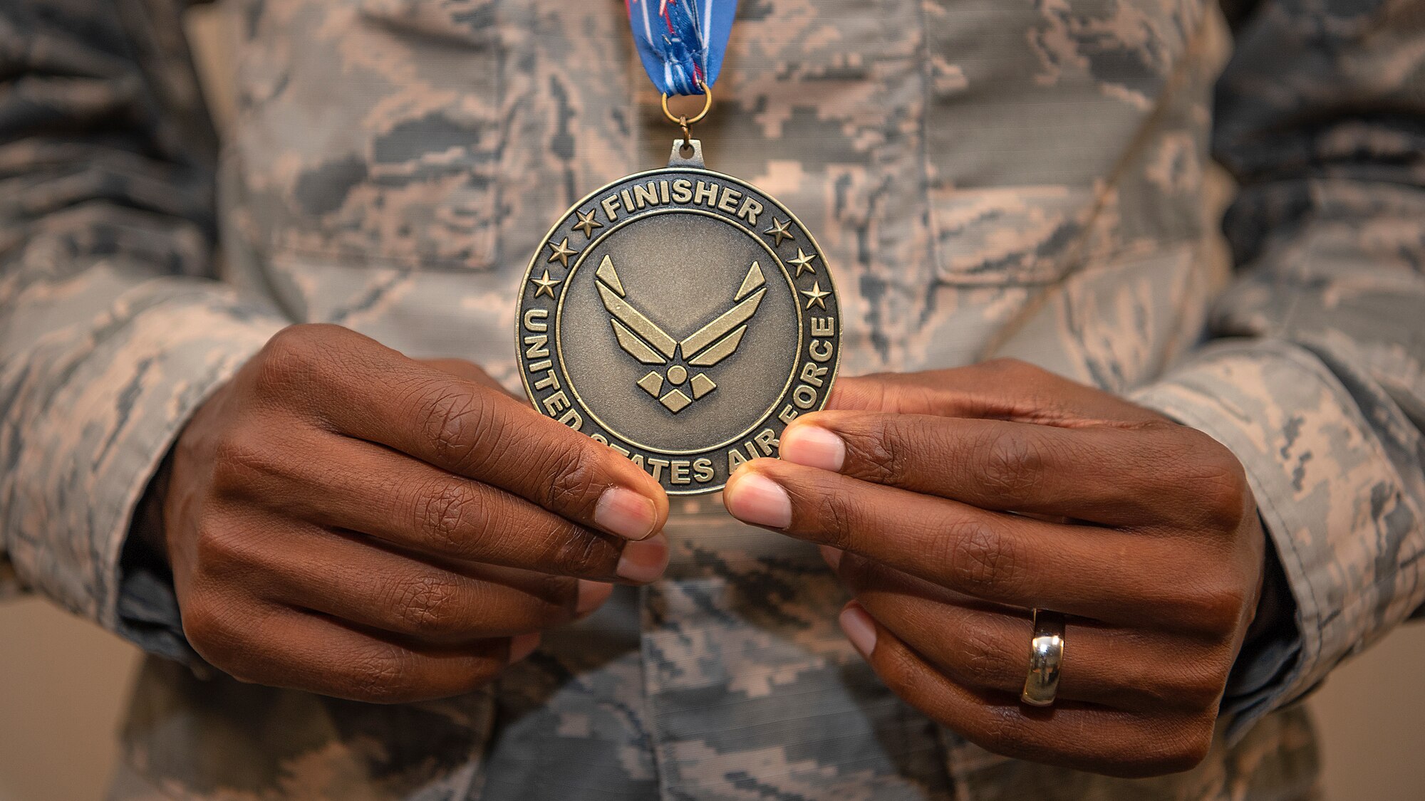 Airman 1st Class Daniel Kirwa, a medical technician assigned to the 6th Healthcare Operations Squadron, pauses for a photo with his finisher medal from the Air Force Marathon, Oct. 9, 2019. Kirwa placed first in the military category of the Air Force Marathon, and third overall, with a time of 2 hours, 33 minutes, and 3 seconds.