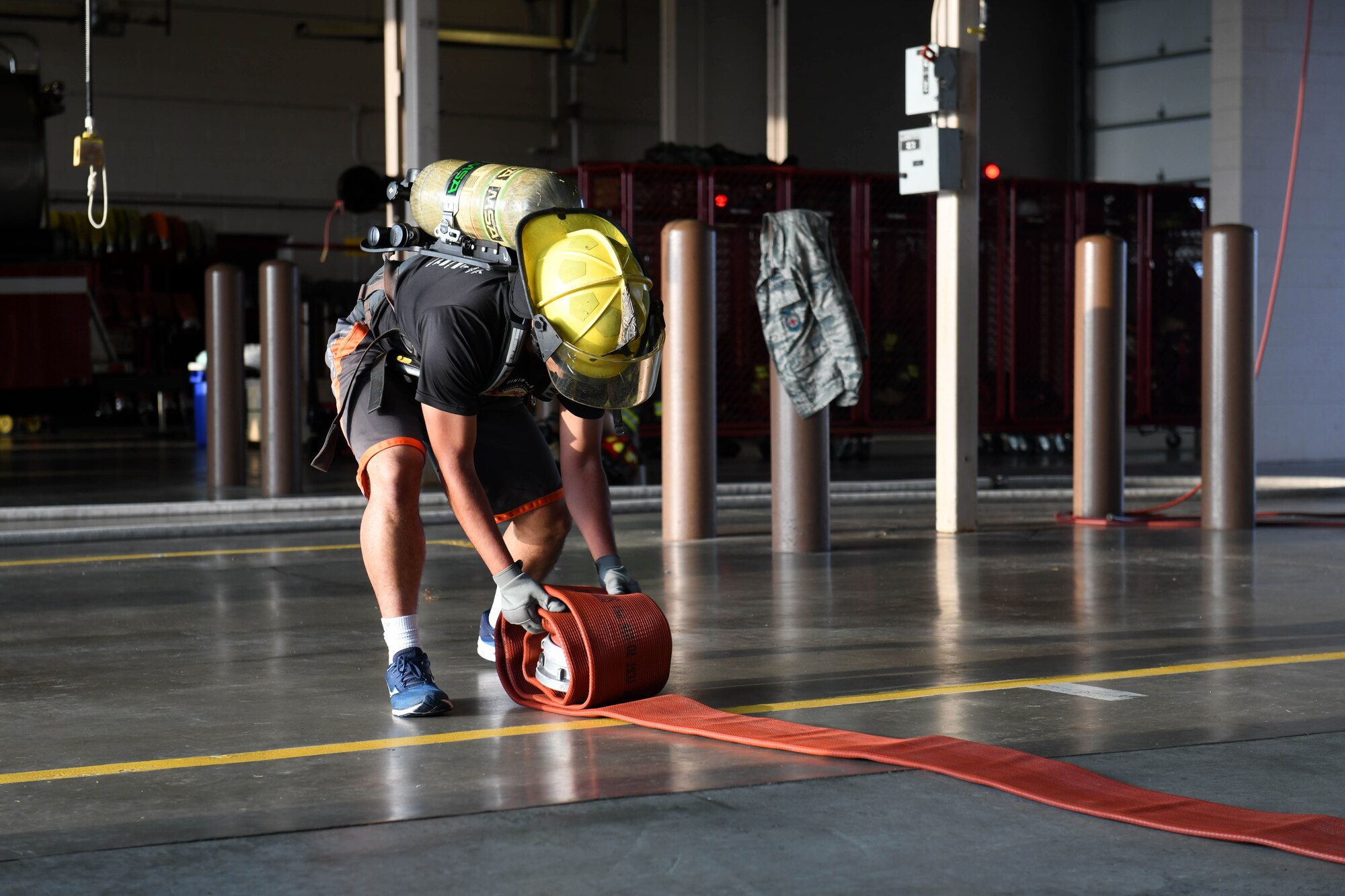 1st Lt. Kyle Ugale, 22nd Civil Engineering Squadron infrastructure optimization engineer, participates in the hose role event in the Fire Muster competition Oct. 10, 2019, at McConnell Air Force Base, Kan. A total of five four-man teams participated in the Fire Muster, which consisted of seven consecutive events, including: a dummy carry, ladder climb and a hose roll. (U.S. Air Force photo by Airman 1st Class Nilsa E. Garcia)