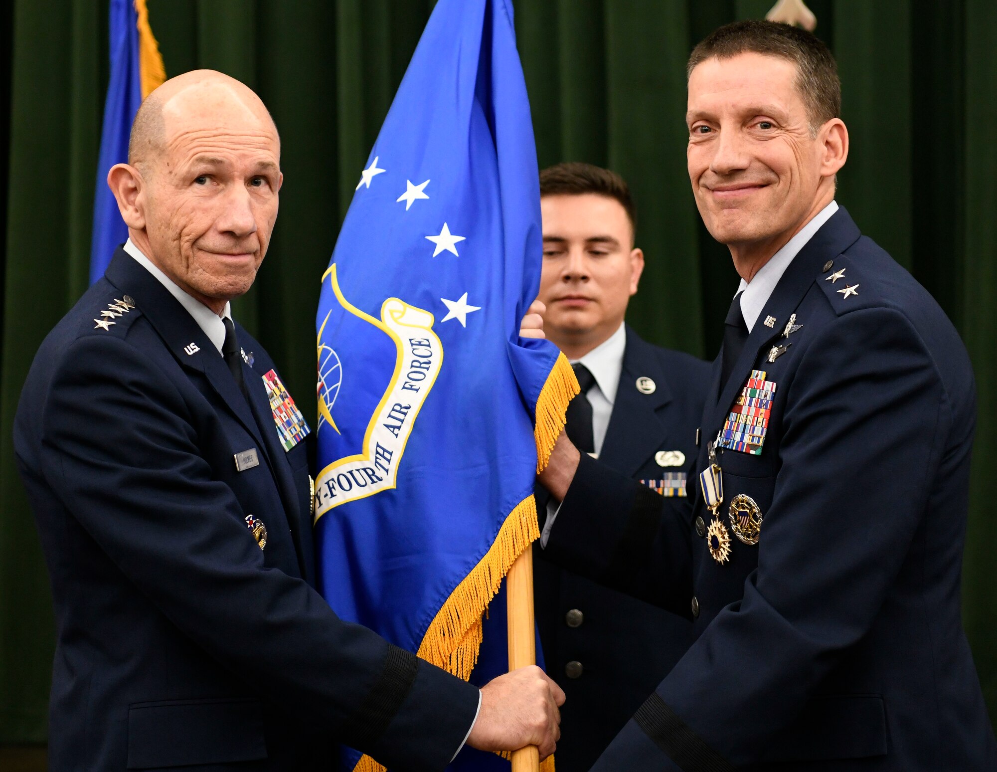 Maj. Gen. Robert Skinner (right) relinquishes command of Twenty-Fourth Air Force to Gen. Mike Holmes, commander of Air Combat Command, during the Sixteenth Air Force Assumption of Command at Joint Base San Antonio-Lackland, Texas, Oct. 11, 2019. Twenty-Fourth and Twenty-Fifth Air Forces were inactivated during the ceremony to integrate into the new information warfare Numbered Air Force. Sixteenth Air Force is responsible for providing IW capabilities to combatant commanders with the speed to match today’s technological environment. (U.S. Air Force photo by Tech. Sgt. R.J. Biermann)