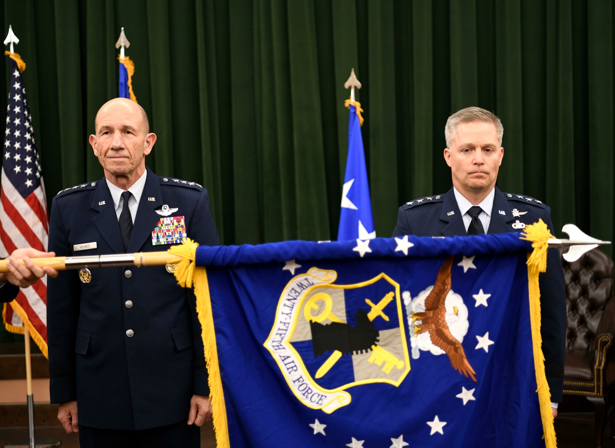 The Twenty-Fifth Air Force flag is furled to signify its inactivation, as Gen. Mike Holmes, commander of Air Combat Command, and Lt. Gen. Timothy Haugh, Twenty-Fifth Air Force commander, look on during the Sixteenth Air Force Assumption of Command at Joint Base San Antonio-Lackland, Texas, Oct. 11, 2019. Twenty-Fourth Air Force was also inactivated during the ceremony to integrate into the new information warfare Numbered Air Force. Sixteenth Air Force is responsible for providing IW capabilities to combatant commanders with the speed to match today’s technological environment. (U.S. Air Force photo by Tech. Sgt. R.J. Biermann)