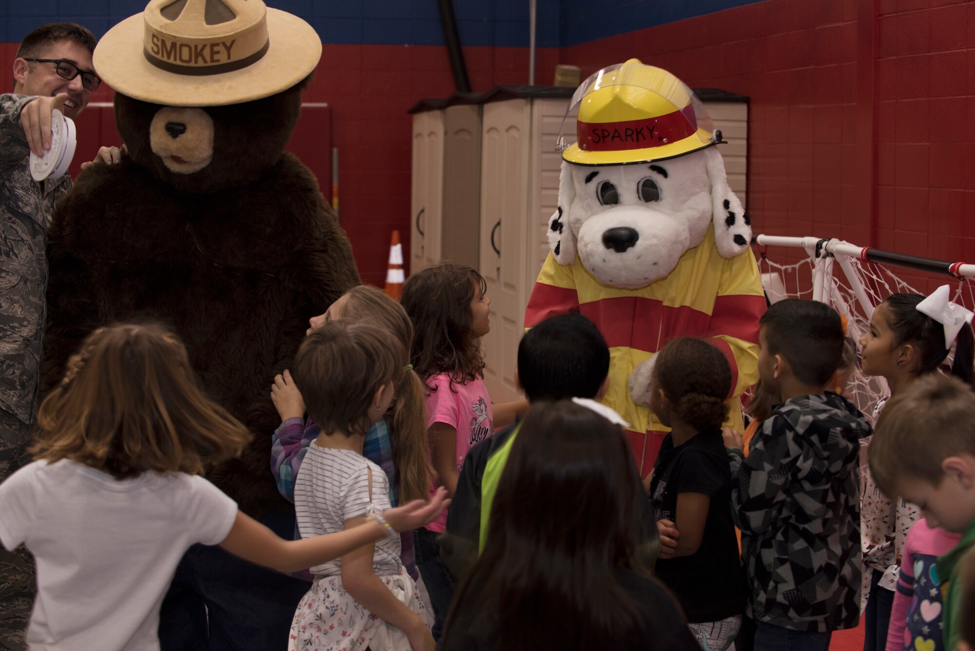 Sparky the Dog and Smokey the Bear, mascots for the Fire and Emergency Services Team at Whiteman Air Force Base, Missouri, talk to first graders from Whiteman Elementary on October 10, 2019. The 2019 Fire Prevention Week campaign theme is "Not Every Hero Wears a Cape. Plan and Practice Your Escape". (U.S. Air Force photo by Staff Sgt. Kayla White)