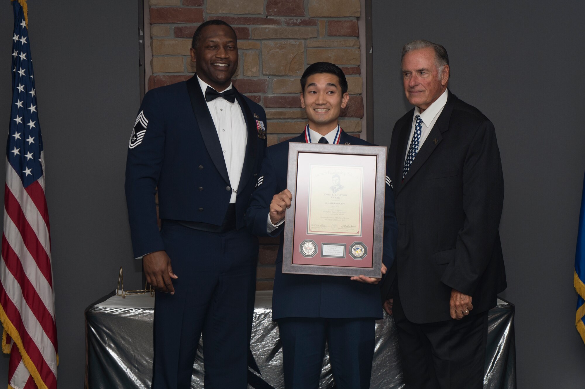 Senior Airman Richard Kim, Airman Leadership School graduate, accepts the John L. Levitow award during the graduation of ALS class 19-7, October 10, 2019, on Holloman Air Force Base, N.M. The John L. Levitow award is presented to the student demonstrating the highest level of leadership and scholastic performance, and is determined by the assignment of points by their peers. (U.S. Air Force photo by Airman 1st Class Kristin Weathersby)