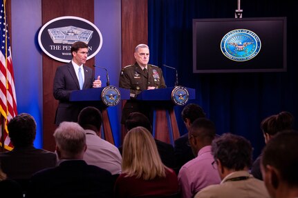 Defense Secretary Dr. Mark T. Esper speaks from a lectern, as Army Gen. Mark A. Milley stands next to him at an identical one.