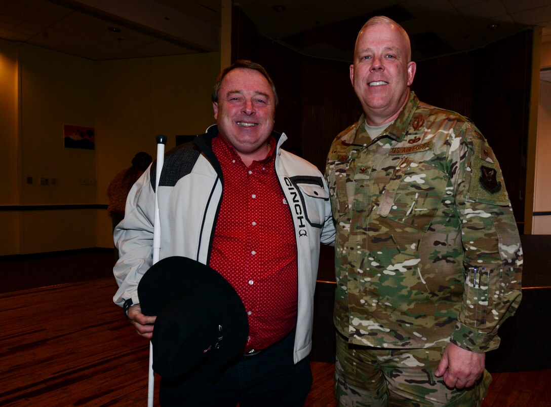 U.S. Air Force Col. Christopher J. King, 377th Air Base Wing vice commander and guest speaker Robert E. Vick Jr., local restauranteur and community advocate for the inclusion of persons with disabilities, pose for a photo after speaking at the hero and exceptional family member program wellness and information fair on Oct. 11 in the Rio Grande Community Center. The purpose of the fair was to encourage the exploration of the latest services, technologies, and adaptive equipment to enrich the lives of those with disabilities. (U.S. Air Force photo by Jessie Perkins)
