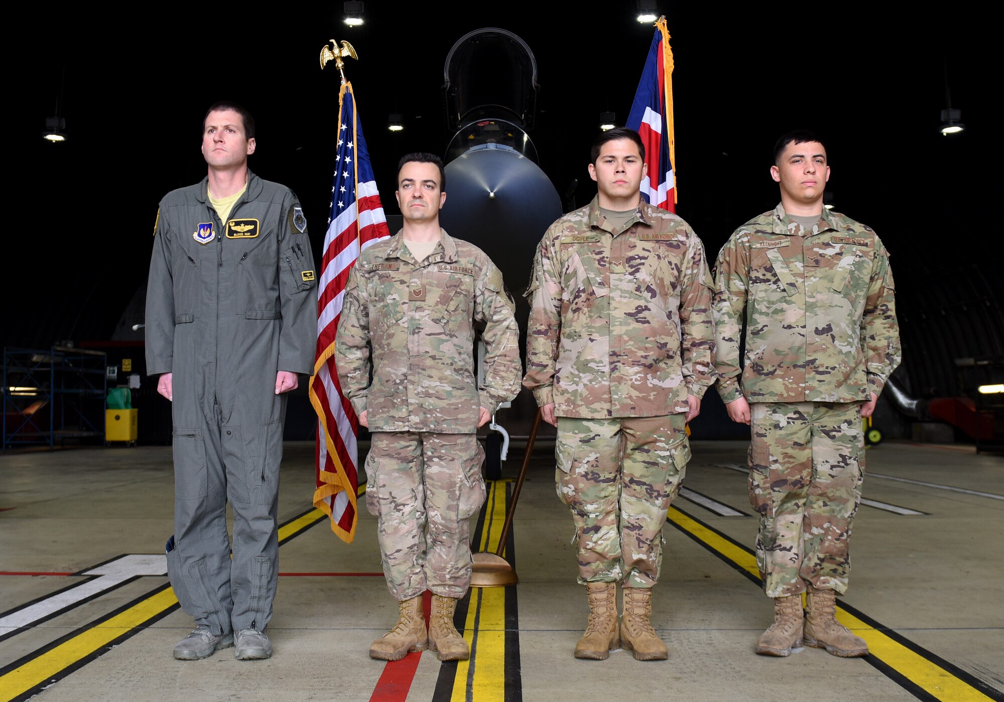 748th Aircraft Maintenance Squadron Airmen, Staff Sgt. Patrick Theran Jr., Senior Airman Jacob Doyle and Airman 1st Class Jimmy Keenright Jr., stand at attention during an Air Force Achievement Medal presentation ceremony at Royal Air Force Lakenheath, England, Oct. 11, 2019. The Liberty Wing Airmen stopped a potentially devastating brake fire from taking the life of the aircrew on board and from destroying a 34 million dollar aircraft, F-15C Eagle, April 29, 2019. (U.S. Air Force photo by Airman 1st Class Madeline Herzog)