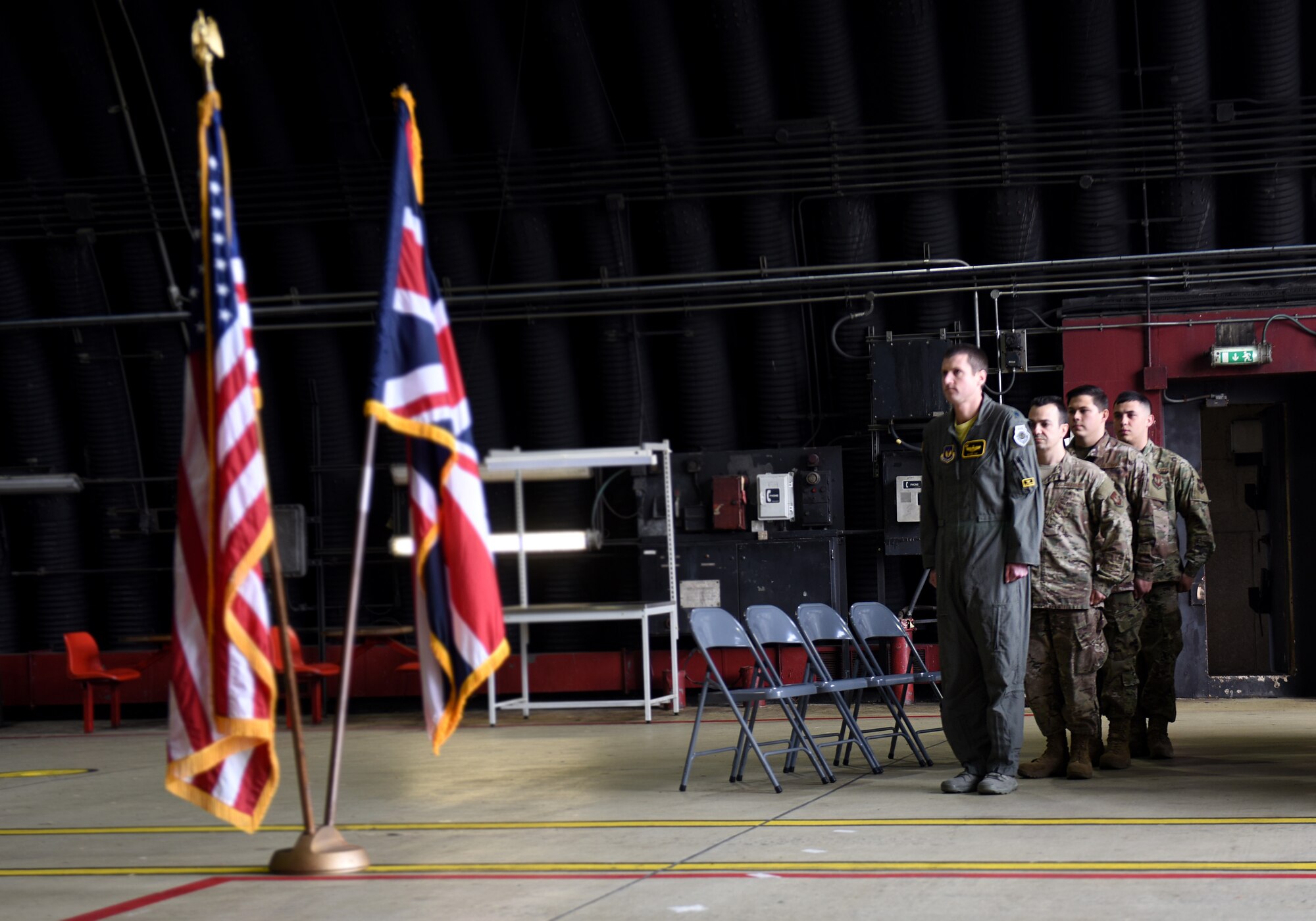 748th Aircraft Maintenance Squadron Airmen, Staff Sgt. Patrick Theran Jr., Senior Airman Jacob Doyle and Airman 1st Class Jimmy Keenright Jr., stand at attention during an Air Force Achievement Medal presentation ceremony at Royal Air Force Lakenheath, England, Oct. 11, 2019. The Liberty Wing Airmen stopped a potentially devastating brake fire from taking the life of the aircrew on board and from destroying a 34 million dollar aircraft, F-15C Eagle, April 29, 2019. (U.S. Air Force photo by Airman 1st Class Madeline Herzog)