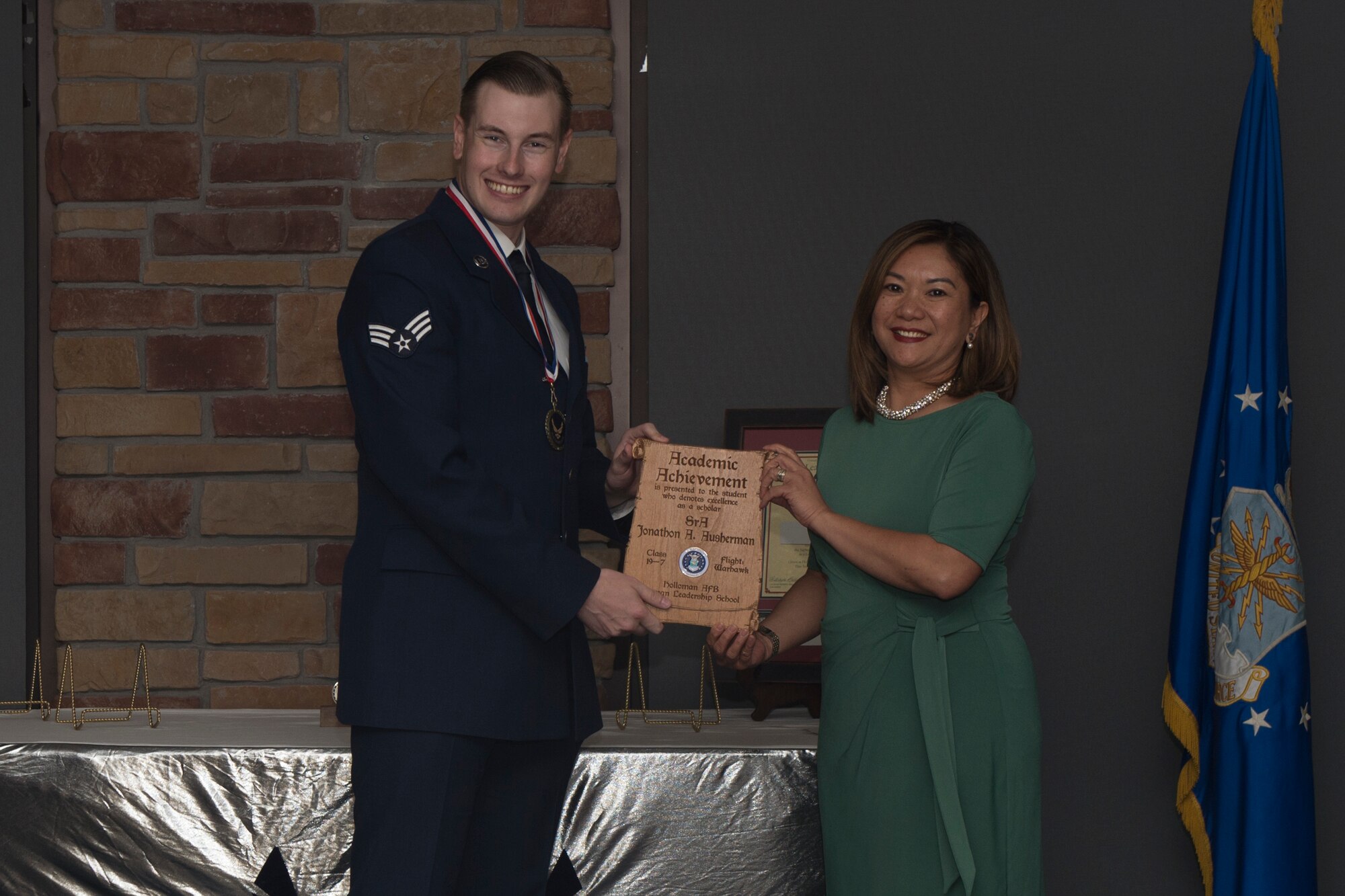 Senior Airman Jonathan Ausherman, Airman Leadership School graduate, accepts the academic award during the graduation of ALS class 19-7, October 10, 2019, on Holloman Air Force Base, N.M. The academic award is presented to the student with the highest overall average on all academic evaluations. (U.S. Air Force photo by Airman 1st Class Kristin Weathersby)