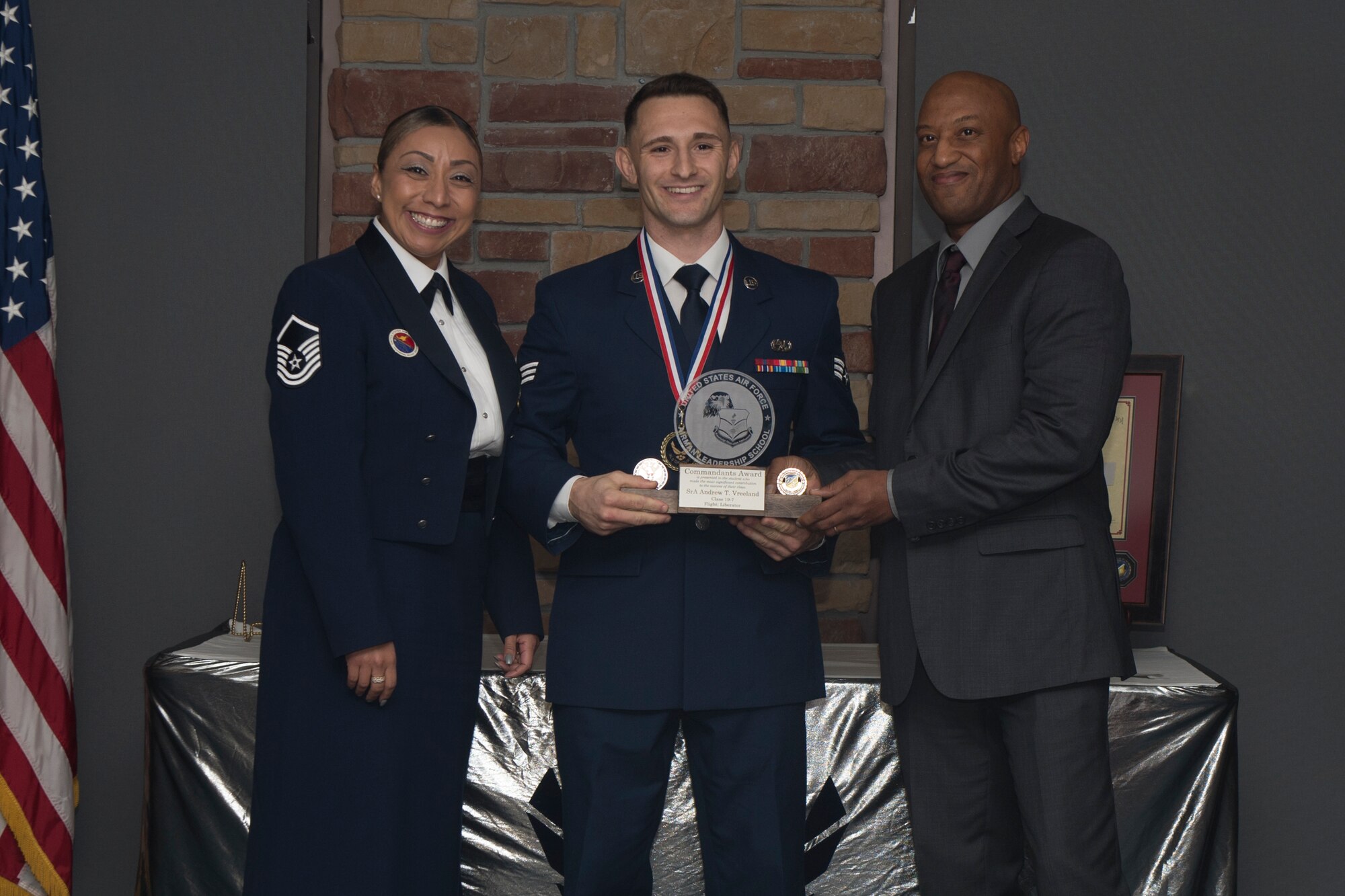 Senior Airman Andrew Vreeland, Airman Leadership School graduate, accepts the commandant leadership award during the graduation of ALS class 19-7, October 10, 2019, on Holloman Air Force Base, N.M. The commandant leadership award is selected by the ALS commandant, and is presented to the student who demonstrates the characteristics of an effective leader. (U.S. Air Force photo by Airman 1st Class Kristin Weathersby)