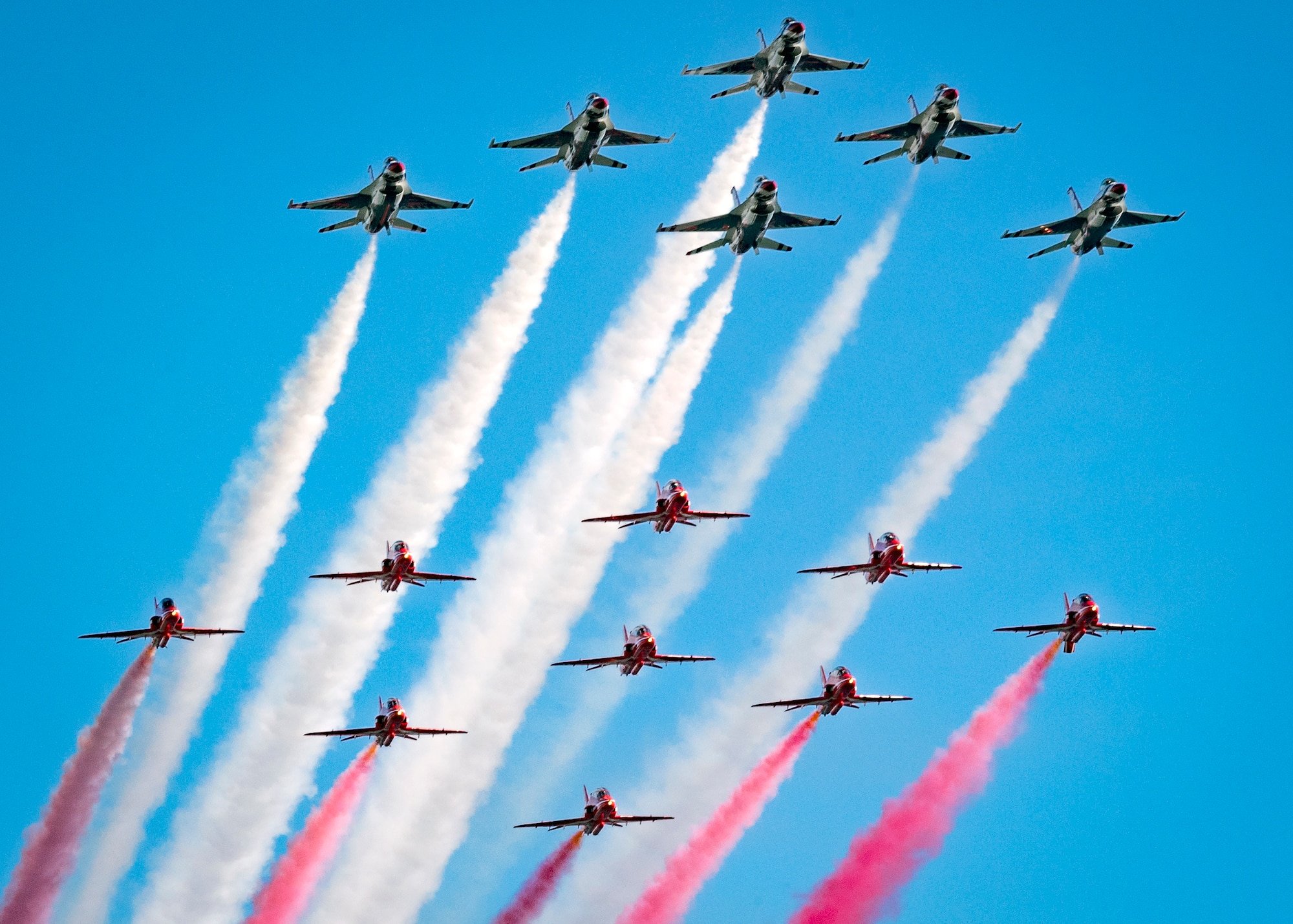 Thunderbirds and the Royal Air Force Red Arrows fly a 15-ship parade-style flat pass