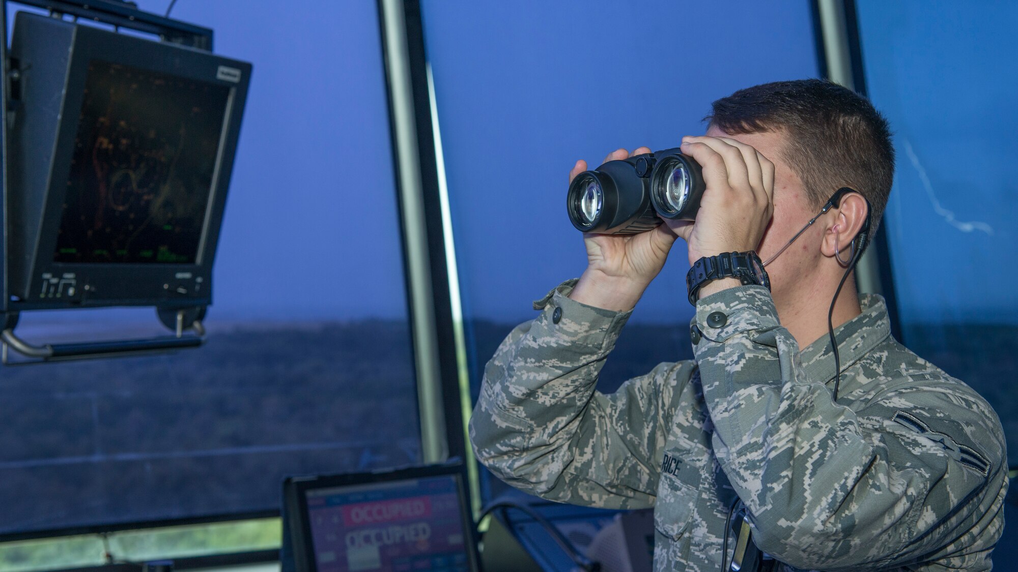 Airman 1st Class Samson Rice, a 6th Operations Support Squadron air traffic control apprentice, checks for incoming aircraft at MacDill Air Force Base, Fla., Oct. 9, 2019.