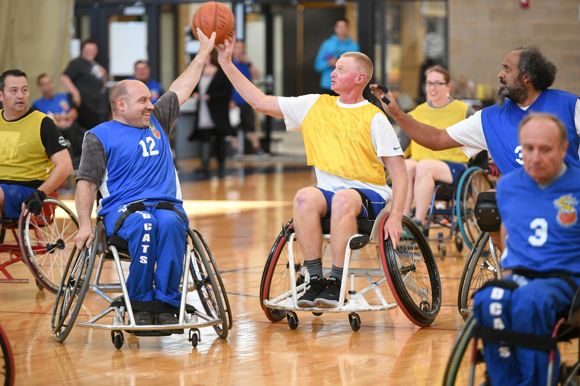 Colonel Jon Eberlan, 75th Air Base Wing commander, spars for ball possession with a player from the Ogden Wheelin' Wildcats during a wheelchair basketball game Oct. 9, 2019 at Hill Air Force Base, Utah. Leaders from Hill's units faced off against the Wheelin' Wildcats, a semi-professional wheelchair basketball team, to celebrate National Disability Employment Awareness Month. (U.S. Air Force photo by Cynthia Griggs)