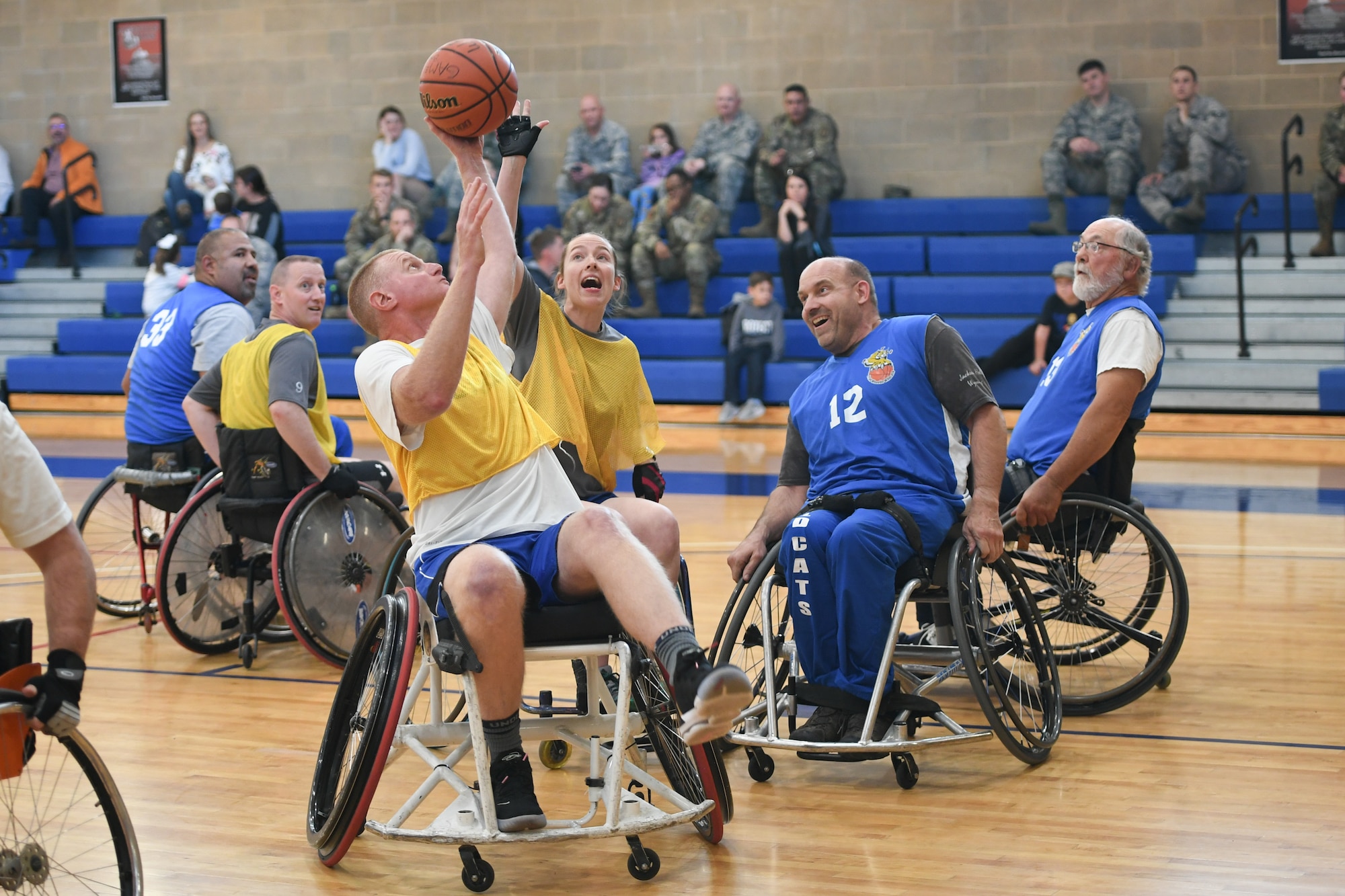 Team Hill players gain possession of the ball during a wheelchair basketball game Oct. 9, 2019 at Hill Air Force Base, Utah. Leaders from Hill's units faced off against the Ogden Wheelin' Wildcats, a semi-professional wheelchair basketball team, to celebrate National Disability Employment Awareness Month. (U.S. Air Force photo by Cynthia Griggs)