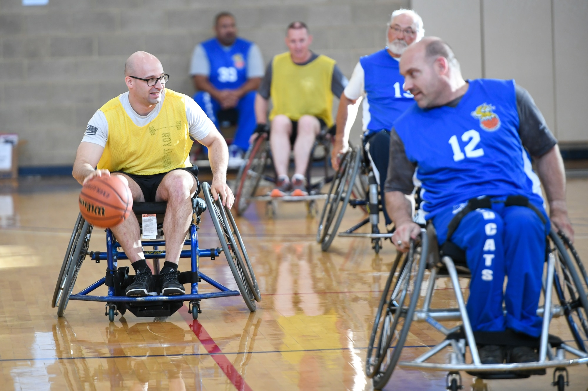 Master Sgt. Albert Lamboy, 75th Logistics Readiness Squadron acting first sergeant, dribbles the ball during a wheelchair basketball game Oct. 9, 2019 at Hill Air Force Base, Utah. Leaders from Hill's units faced off against the Ogden Wheelin' Wildcats, a semi-professional wheelchair basketball team, to celebrate National Disability Employment Awareness Month. (U.S. Air Force photo by Cynthia Griggs)