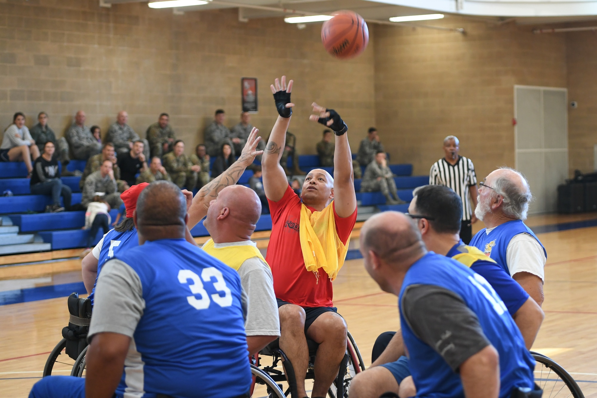 A member from Team Hill shoots the ball during a wheelchair basketball game Oct. 9, 2019 at Hill Air Force Base, Utah. Leaders from Hill's units faced off against the Ogden Wheelin' Wildcats, a semi-professional wheelchair basketball team, to celebrate National Disability Employment Awareness Month. (U.S. Air Force photo by Cynthia Griggs)