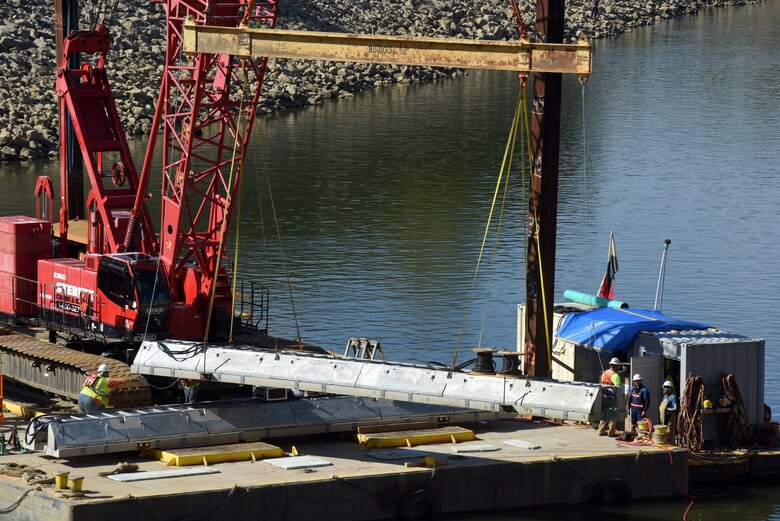 Fish Guidance Systems crew prepares to install a section of the bio acoustic fish fence Oct. 9, 2019 on the riverbed below Barkley Lock in Grand Rivers, Ky. The BAFF is expected to be operational in a few weeks, and a field trial is set to test the effectiveness.  The project involves multiple agencies and partners, including U.S. Fish and Wildlife Service, Kentucky Department of Fish and Wildlife Resources, U.S. Army Corps of Engineers Nashville District, U.S. Geological Survey and Tennessee Wildlife Resources Agency. (USACE photo by Lee Roberts)
