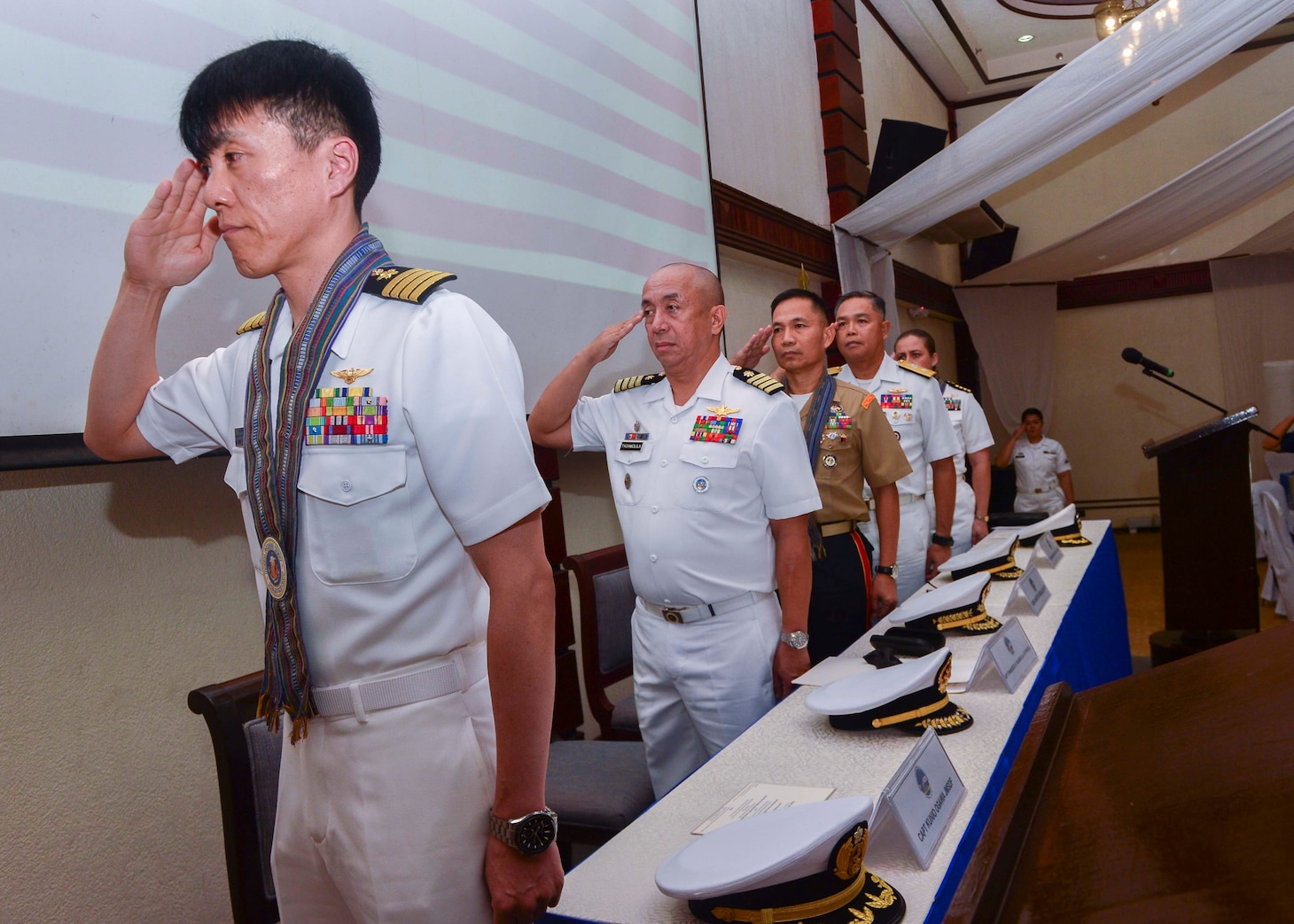 PUERTO PRINCESA (Oct. 14, 2019) - Leaders from the Japan Maritime Self-Defense Force, Philippine Navy and U.S. Navy salute during the opening ceremony for Maritime Training Activity (MTA) Sama Sama. Now in its third year, MTA Sama Sama includes forces from Japan, Philippines and the United States, and is designed to promote regional security cooperation, maintain and strengthen maritime partnerships, and enhance maritime interoperability.