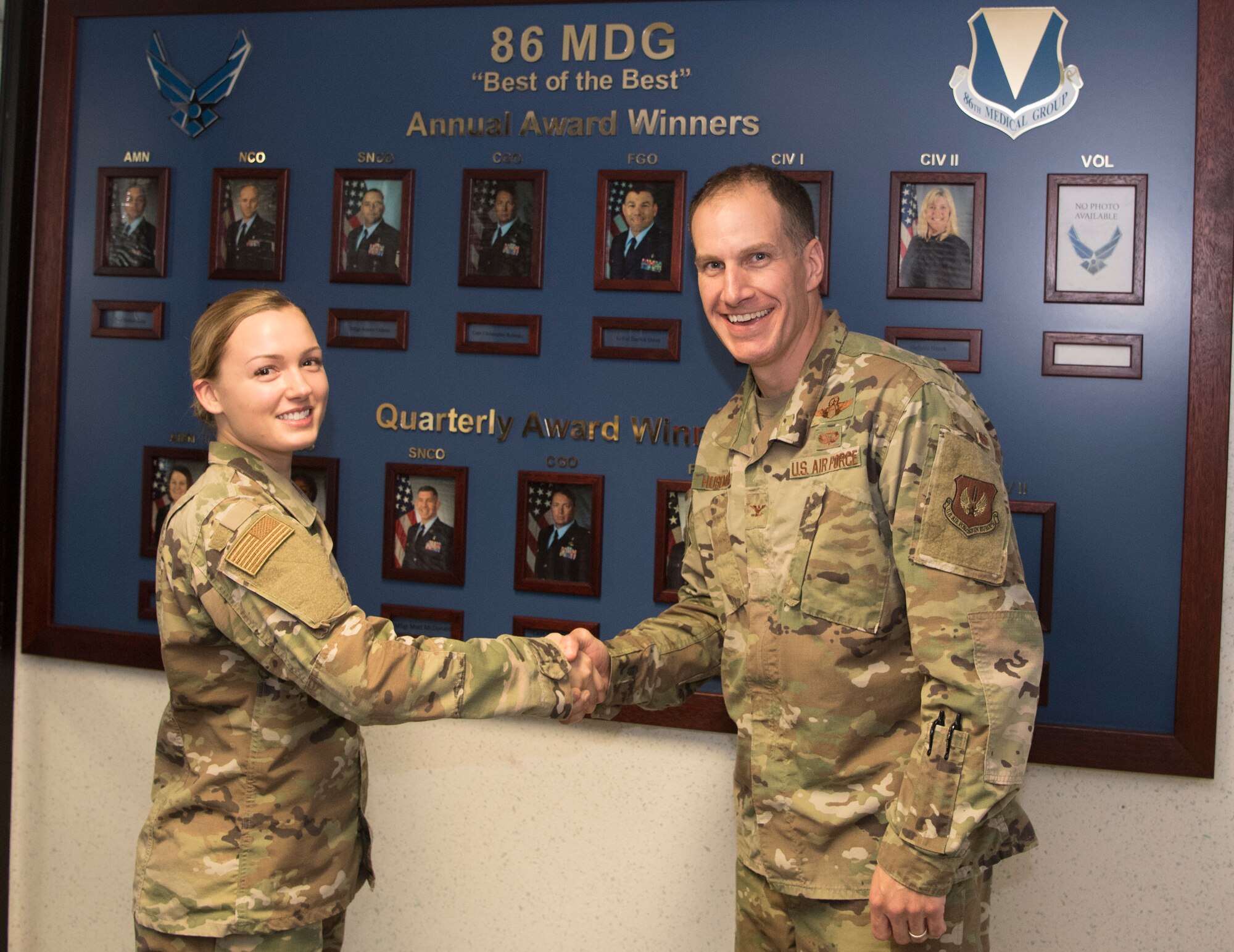 U.S. Air Force Col. Matthew S. Husemann, 86th Airlift Wing vice commander, poses for a photo with Senior Airman April VanHorn, 86th Aerospace Medical Squadron medical technician, to recognize her as Airlifter of the Week at Ramstein Air Base, Germany, Oct. 11, 2019. VanHorn received the award after streamlining several processes prior to a group inspection and for her proactiveness in providing first response action to an unconscious individual during a trip to Oktoberfest. (U.S. Air Force photo by Senior Airman Kristof J. Rixmann)