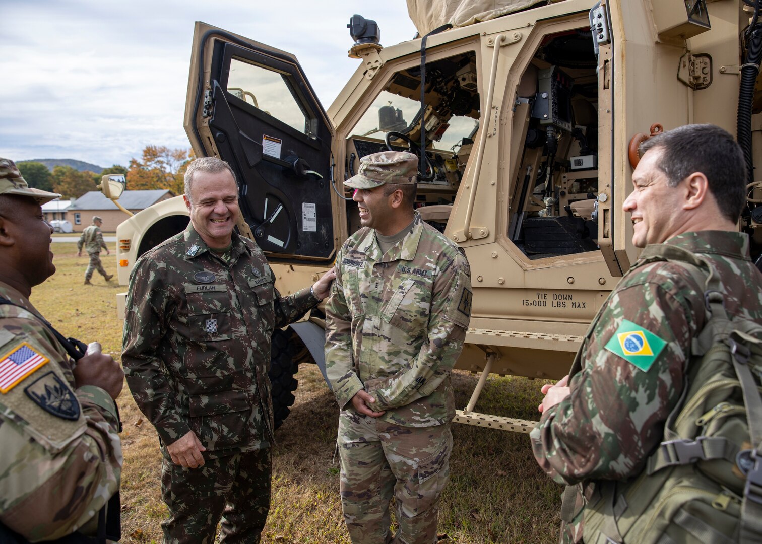 Lt. Gen. Achilles Furlan Neto, the Brazilian Army's operations officer, shares a laugh with New York Army National Guard Soldiers while touring a display of equipment on the parade field at the Camp Smith Training Site in Cortlandt Manor, N.Y., Oct. 8, 2019. The New York Army National Guard has had a partnership with Brazil under the State Partnership Program since March 2019.