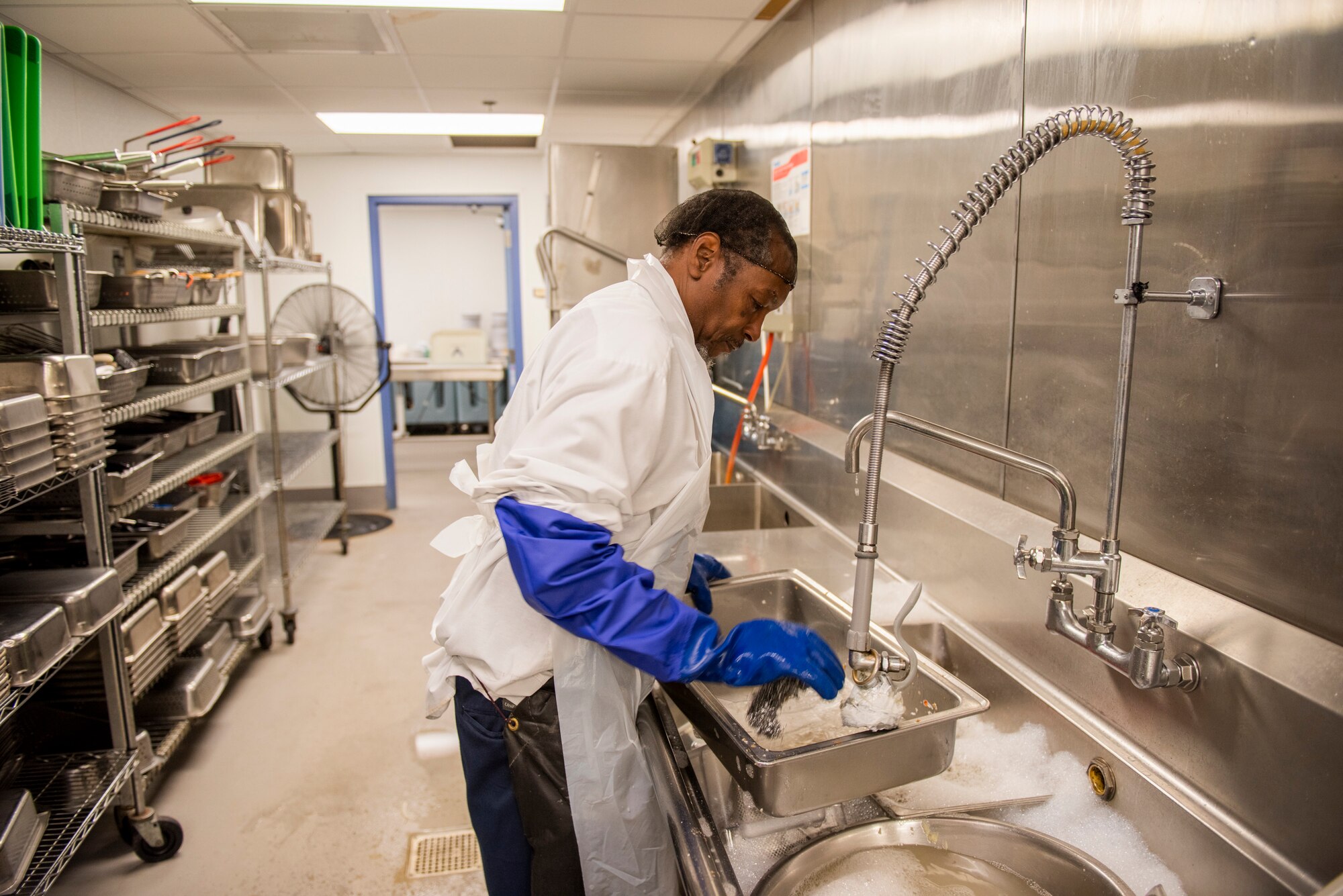Carlton Witherspoon, 23d Force Support Squadron (FSS) dining facility (DFAC) contractor, washes table pans Oct. 8, 2019, at Moody Air Force Base, Ga. Airmen assigned to the Georgia Pines DFAC prepare food, perform quality-control inspections and provide meal service for more than 700 Airmen daily. FSS Airmen also provide support in the areas of child development, food service, lodging, recreation, fitness, mortuary affairs and youth services as well as promoting individual, unit, family and community well-being. (U.S. Air Force photo by Airman Elijah M. Dority)