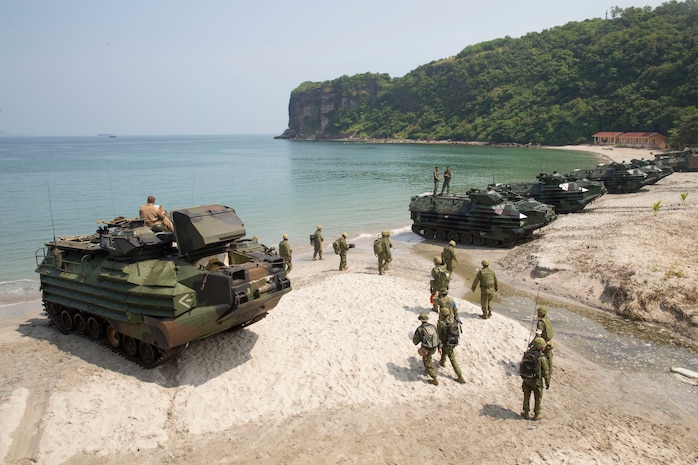 U.S. Marine, Philippine Marine and Japan Ground Self-Defense Force members assault amphibious vehicles line up along the shore following an amphibious exercise as part of KAMANDAG 3 at Katungkulan Beach, Marine Barracks Gregorio Lim, Philippines, Oct. 12.