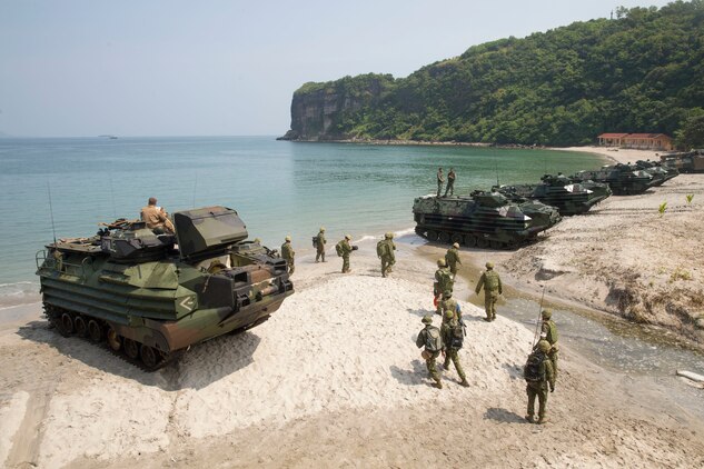 U.S. Marine, Philippine Marine and Japan Ground Self-Defense Force members assault amphibious vehicles line up along the shore following an amphibious exercise as part of KAMANDAG 3 at Katungkulan Beach, Marine Barracks Gregorio Lim, Philippines, Oct. 12, 2019. KAMANDAG helps participating forces maintain a high level of readiness and responsiveness, and enhances combined military-to-military relations, interoperability, and multinational coordination. KAMANDAG is an acronym for the Filipino phrase “Kaagapay Ng Mga Manirigma Ng Dagat,” which translates to “Cooperation of the Warriors of the Sea,” highlighting the partnership between the U.S. and Philippine militaries.