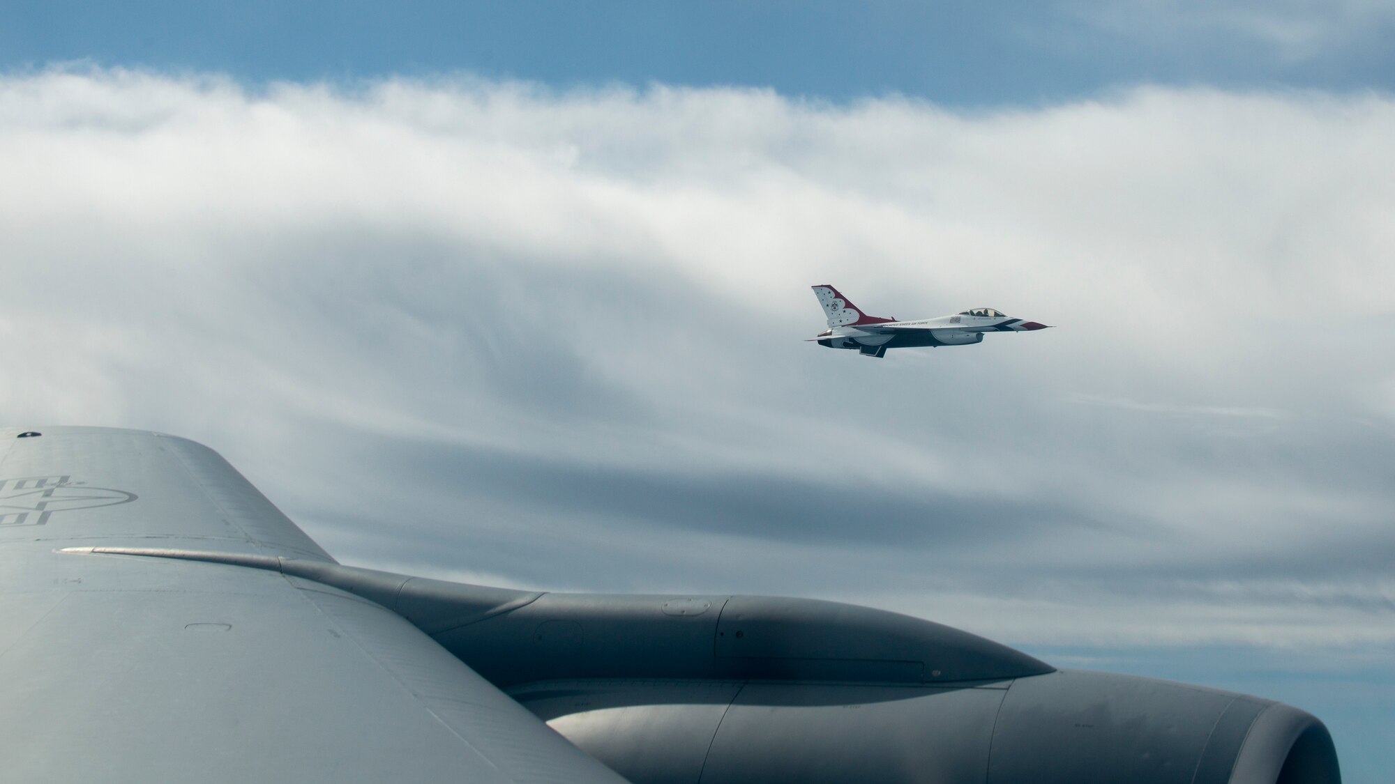 A United States Air Force Air Demonstration Squadron “Thunderbird” flies alongside a KC-135 Stratotanker assigned to MacDill Air Force Base, Fla., Oct. 14, 2019. The Thunderbirds are a flying aerobatic team that performs at air shows around the world.