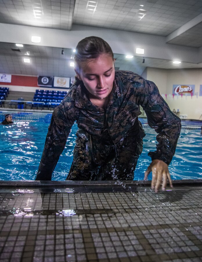 U.S. Marine Corps Lance Cpl. Morgan L. Rhinehart, an air transportation coordination office clerk with 4th Marine Aircraft Wing, exits a pool during a bi-annual swim qualification course at the University of New Orleans, Oct. 11, 2019. The Marine Corps Water Survival Training Program employs water survival skills to reduce fear, raise self-confidence, and develop Marines with the ability to survive in water. (U.S. Marine Corps photo by Lance Cpl. Jose Gonzalez)