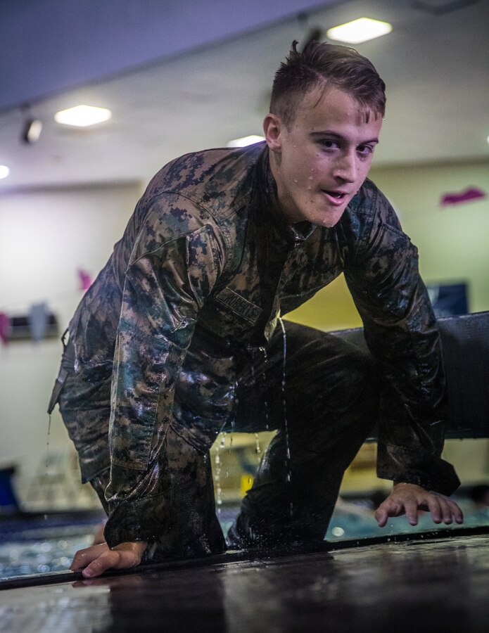 U.S. Marine Corps Cpl. Christopher L. Roberts, a maintenance management clerk with G-4, exits a pool during a bi-annual swim qualification course at the University of New Orleans, Oct. 11, 2019. Reserve Marines complete their swim qualification to remain deployable and maintain overall unit readiness and fitness. (U.S. Marine Corps photo by Lance Cpl. Jose Gonzalez)