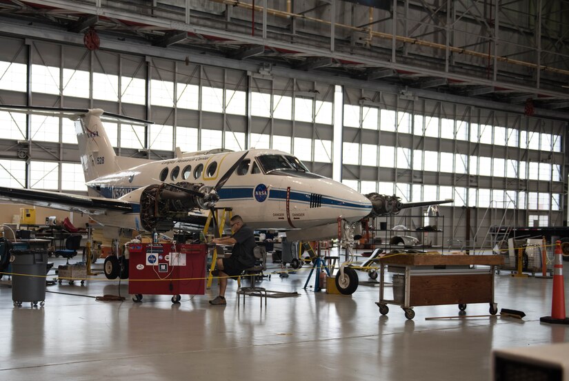 A NASA employee works on a plane used for research and development missions at the Langley Research Center in Hampton, Virginia, Oct. 9, 2019. Personnel from Joint Base Langley-Eustis and military liaison representatives of several Virginia senators’ offices took part in a tour of the facilities and the hangar at the LaRC. (U.S. Air Force photo by Airman 1st Class Sarah Dowe)