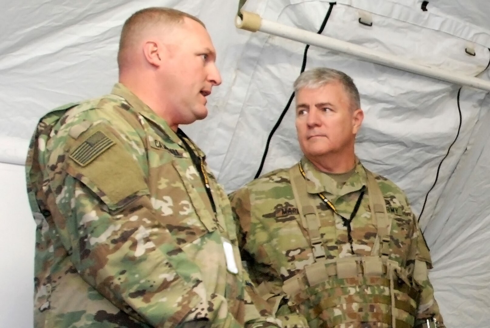 South Dakota Army National Guard Adjutant General Maj. Gen. Jeffrey Marlette, right, talks with Lt. Col. Jason Campbell, command judge advocate with the 196th Maneuver Enhancement Brigade, at a simulated wartime exercise Sept. 25-Oct. 12 in Joint Base Lewis-McChord, Wash.