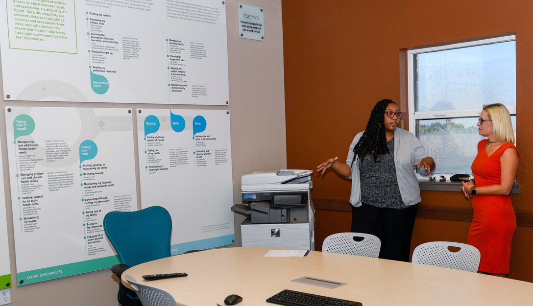 Antonish Dorsey, Military and Veterans Success Center program manager, explains the Journeys of Veterans Map to U.S. Sen. Kyrsten Sinema of Arizona, Oct. 9, 2019, at Luke Air Force Base, Ariz.