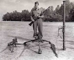 Technical Sgt. Francis S. Currey, Company K, 120th Infantry Regiment, 30th Infantry Division, poses July 26, 1945, with the weapons he used while halting a German attack on his company Dec. 21,1944, during the Battle of the Bulge. Maj. Gen. Leland S. Hobbs, commanding general, 30th Infantry Division, presented him with the nation's highest award, the Medal of Honor, near Reims, France.