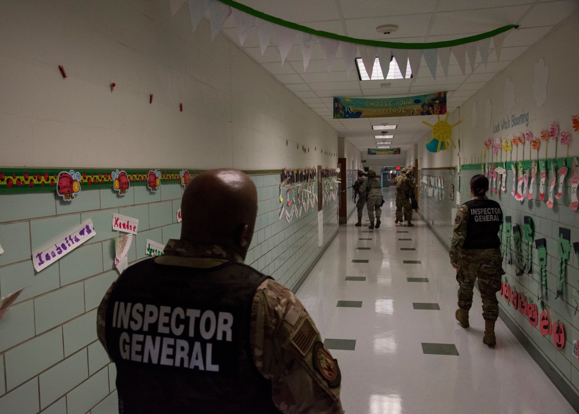 Inspectors watch as a four-man fire team from the 436th Security Forces Squadron clears rooms at a school Oct. 11, 2019, at Dover Air Force Base, Del. Security forces fire teams kept in contact with one another to ensure each other’s locations and safety. (U.S. Air Force photo by Airman 1st Class Jonathan Harding)