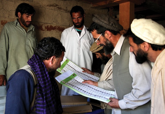 In August 2009, Afghan locals review ballots before voting in the heavily anticipated Afghanistan elections in Barge Matal. Elections are frequently a priority of the international community in post-conflict and even in conflict-afflicted states. (U.S. Army/ Christopher W. Allison)