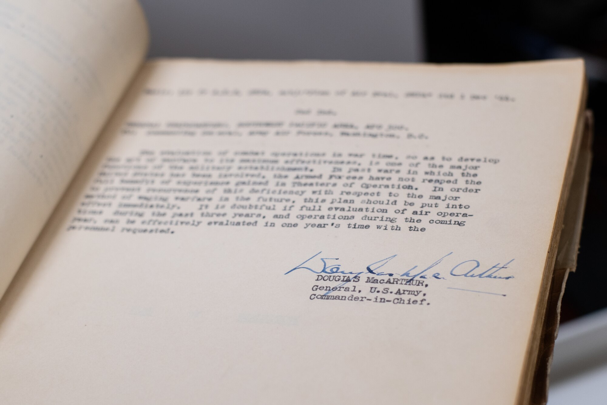 An Air University Library employee holds a historical document signed by former Commander-in-Chief, U.S. Army Gen. Douglas MacArthur, Aug. 22, 2019, on Maxwell Air Force Base, Alabama. This document is just one of many historical products the Air University Library is digitizing, making it available to DOD employees, regardless of location.