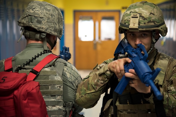 Staff Sgts. Harold Snyder (right), 436th Security Forces Squadron flight sergeant, and Tim Endres, 436th SFS response force leader, take up a defensive position,  covering multiple angles Oct. 11, 2019, at Dover Air Force Base, Del. Teams of two opened individual rooms in search of potential threats or faculty members. (U.S. Air Force photo by Airman 1st Class Jonathan Harding)