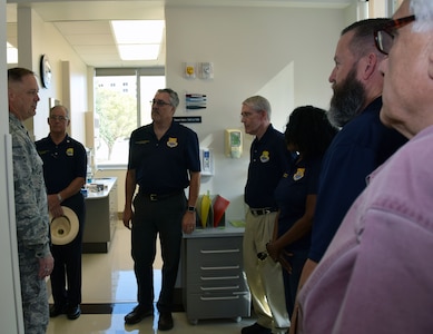 Lt. Col. Michael J. Bates, 433rd Aerospace Medicine Squadron dentist, guides 433rd honorary commanders for an inside look at the Air Force Postgraduate Dental School and Clinic during a tour of the facility Oct. 5 at Joint Base San Antonio-Lackland.