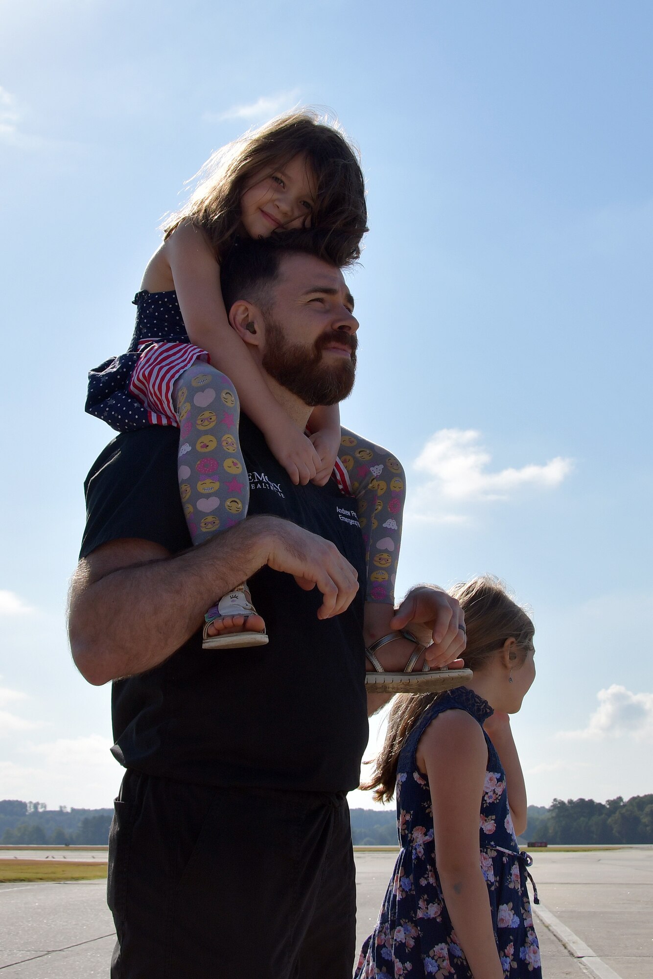 Andrew Pendley and his two children watch as his wife, Tracey Pendley, an Atlanta Public Schools fourth grade teacher, flies with the U.S. Air Force Thunderbirds at Dobbins Air Reserve Base, Ga. on Oct. 11, 2019. In addition to being named Georgia’s Teacher of the Year, Tracey was also nominated as a Hometown Hero, a program which allows exceptional community members to be nominated for a familiarization flight in a Thunderbirds jet, an F-16 Fighting Falcon. (U.S. Air Force photo/Airman Kendra A. Ransum)