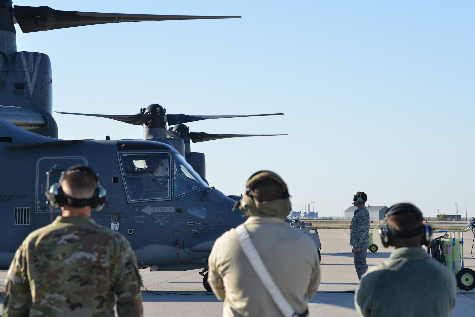 Members of the 71st Aircraft Maintenance Unit look on during pre-flight checks at Kirtland Air Force Base, N.M., Oct. 7, 2019. Over the last fiscal year, the AMU hit their 1,500 flight hour goal for the CV-22 Osprey. The mission of the 71st AMU is to provide mission ready CV-22 Ospreys for the 71st Special Operations Squadron. (U.S. Air Force photo by Staff Sgt. Dylan Nuckolls)